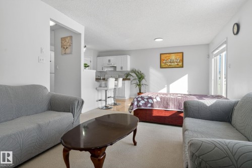 Open concept living space with light-colored walls and carpeted flooring - 421 84 Street, Edmonton, AB - Indoor Photo Showing Living Room
