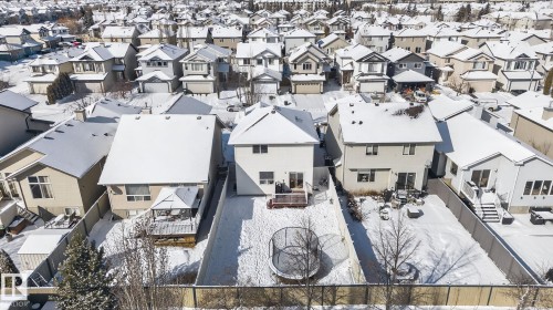 This property features a fenced backyard with a patio area and a trampoline, offering private outdoor space - 421 84 Street, Edmonton, AB - Outdoor With Facade