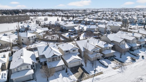 Aerial view of a residential neighborhood featuring detached properties with snow-covered roofs and visible driveways - 421 84 Street, Edmonton, AB - Outdoor