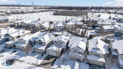 Aerial view of a residential area featuring detached properties with snow-covered roofs and yards - 421 84 Street, Edmonton, AB - Outdoor