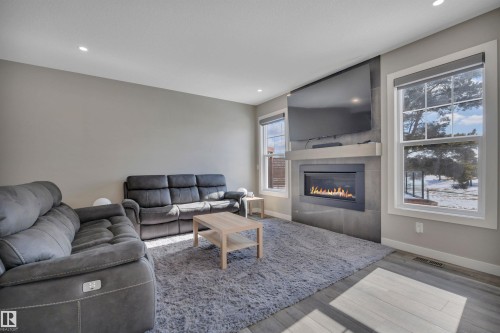 15 Promenade Point(E), Beaumont, AB - Indoor Photo Showing Living Room With Fireplace