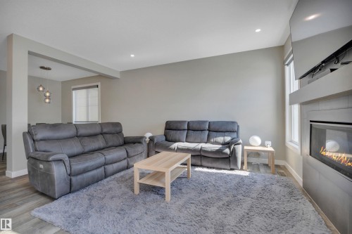 15 Promenade Point(E), Beaumont, AB - Indoor Photo Showing Living Room With Fireplace