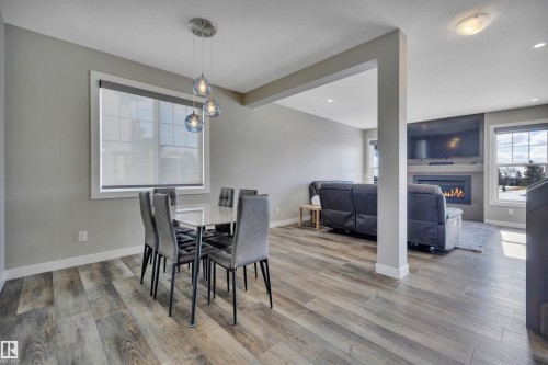 15 Promenade Point(E), Beaumont, AB - Indoor Photo Showing Dining Room With Fireplace