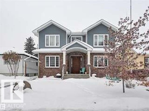 The property features a brick and siding exterior with a welcoming covered front entry - 10836 130 Street, Edmonton, AB - Outdoor