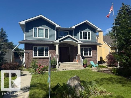 Two-story residence featuring a brick and siding exterior, multiple gables, white window frames, and a covered entry porch supported by columns - 10836 130 Street, Edmonton, AB 