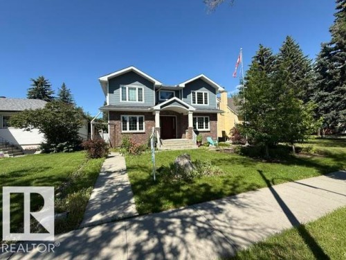 Two-story residence featuring a brick first level and blue siding on the second level with white trim - 10836 130 Street, Edmonton, AB 