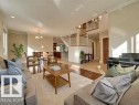 The property features an open-concept living space with hardwood flooring, high ceilings with recessed lighting, and a dining area with a chandelier - 10836 130 Street, Edmonton, AB  - Indoor Photo Showing Living Room 