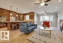 The property features an open-concept living area with tile flooring and ceiling fans - 10836 130 Street, Edmonton, AB  - Indoor Photo Showing Living Room 