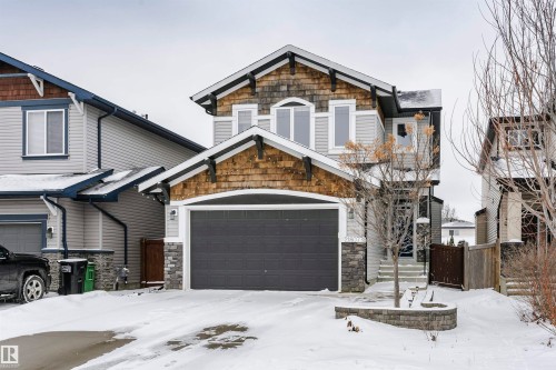 The property features a two-story exterior with light gray siding and wood-shingle accents - 21807 97 Avenue, Edmonton, AB - Outdoor