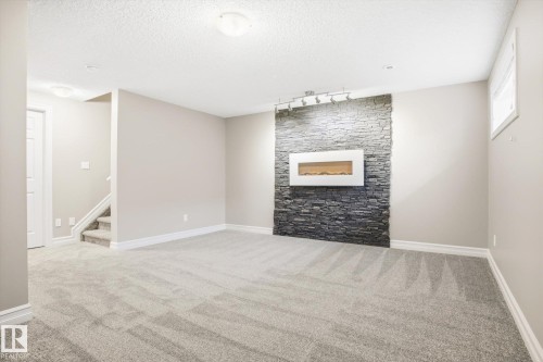 6861 Cardinal Link, Edmonton, AB - Indoor Photo Showing Other Room With Fireplace