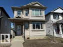 The property features light-colored horizontal siding, a covered front entrance with steps, and multiple windows with white frames - 21316 95 Avenue, Edmonton, AB  - Outdoor With Facade 