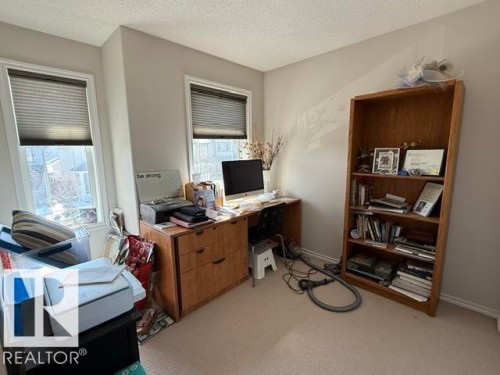 This room features two windows with blinds, light-colored walls, and carpeting - 21316 95 Avenue, Edmonton, AB - Indoor Photo Showing Office