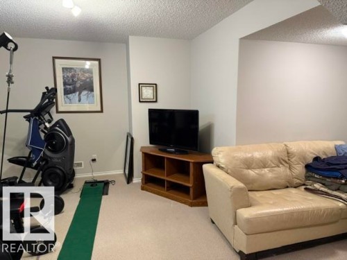 Recessed ceiling lighting illuminates a versatile space featuring neutral wall tones and a textured ceiling - 21316 95 Avenue, Edmonton, AB - Indoor