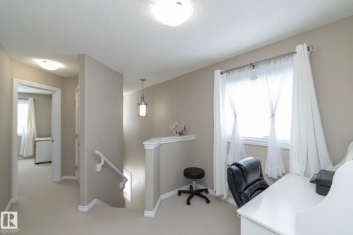 The property features a well-lit area with a window providing natural light, a desk, and neutral-toned walls - 132 Kirpatrick Way, Leduc, AB - Indoor