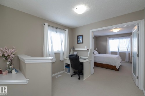 This property features a well-lit interior with neutral-toned walls and light-colored carpeting - 132 Kirpatrick Way, Leduc, AB - Indoor Photo Showing Bedroom