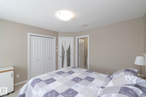 Bedroom with light-colored walls and white trim, featuring a flush-mount ceiling light and a speaker in the ceiling - 132 Kirpatrick Way, Leduc, AB - Indoor Photo Showing Bedroom