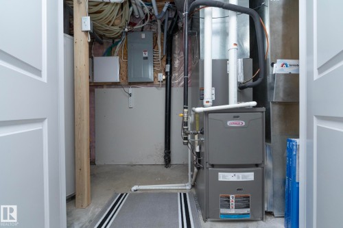 This property features a Lennox furnace and water heater, with exposed ductwork and electrical panels - 132 Kirpatrick Way, Leduc, AB - Indoor Photo Showing Basement