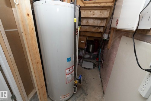 Utility area featuring a water heater and electrical outlets - 132 Kirpatrick Way, Leduc, AB - Indoor Photo Showing Basement