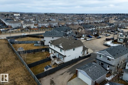 The property features a spacious yard with fencing, a shed, and a deck - 132 Kirpatrick Way, Leduc, AB - Outdoor With View