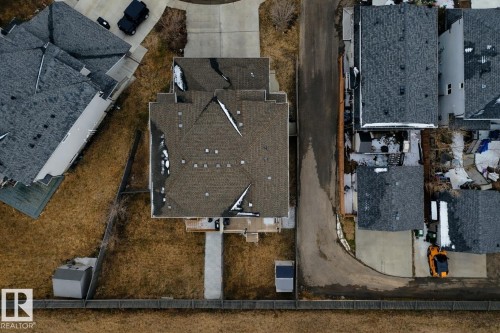 Aerial view of the property, featuring a multi-gabled roof and a paved driveway - 132 Kirpatrick Way, Leduc, AB - Outdoor
