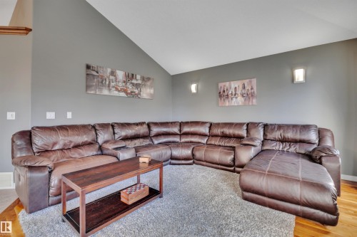 Living area with vaulted ceilings, grey walls, and hardwood flooring - 316 Avena Link, Leduc, AB - Indoor Photo Showing Living Room