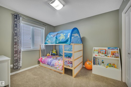 This room features a window with blinds and curtains, carpeted flooring, and a light-colored painted wall - 316 Avena Link, Leduc, AB - Indoor Photo Showing Bedroom