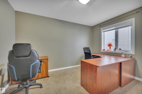 This versatile room features neutral-toned walls, carpeted flooring, and a window with blinds, allowing for natural light - 316 Avena Link, Leduc, AB - Indoor Photo Showing Office