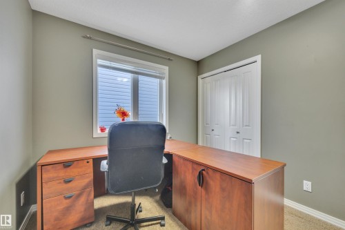 This room features a window providing natural light, neutral-toned walls, and carpeted flooring - 316 Avena Link, Leduc, AB - Indoor Photo Showing Office