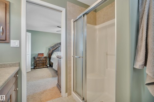 Bathroom featuring a shower with a sliding glass door and tiled walls - 316 Avena Link, Leduc, AB - Indoor Photo Showing Bathroom
