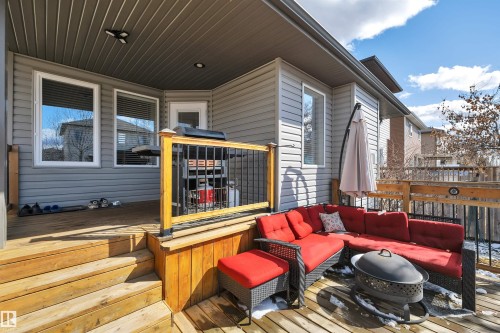 The property features a spacious wooden deck with a covered area, ideal for outdoor living - 316 Avena Link, Leduc, AB - Outdoor With Deck Patio Veranda With Exterior
