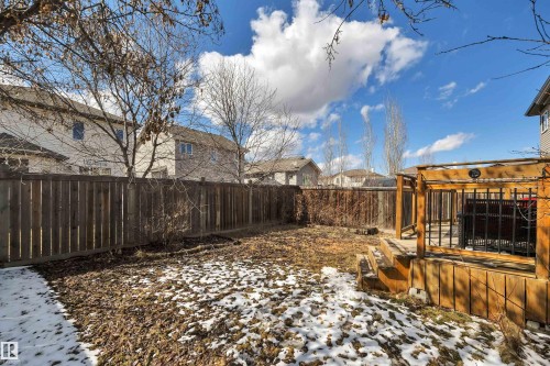 The property features a wood deck with a pergola, a wooden privacy fence, and a yard - 316 Avena Link, Leduc, AB - Outdoor