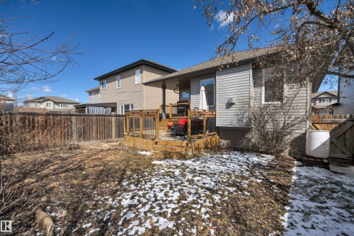 The property features a wooden deck with a railing and steps, accessible via a glass door - 316 Avena Link, Leduc, AB - Outdoor With Deck Patio Veranda