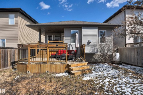 The property features a wooden deck with railing, accessible via steps, and a covered patio area - 316 Avena Link, Leduc, AB - Outdoor With Deck Patio Veranda