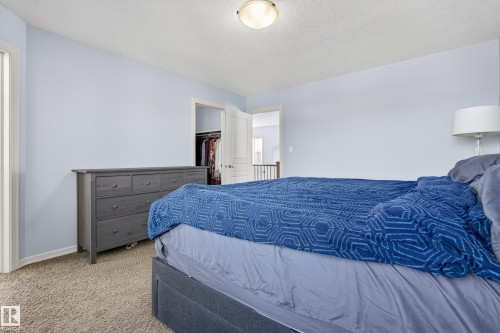Bedroom featuring light blue walls, carpeted flooring, and a ceiling light fixture - 20714 56A Avenue, Edmonton, AB - Indoor Photo Showing Bedroom