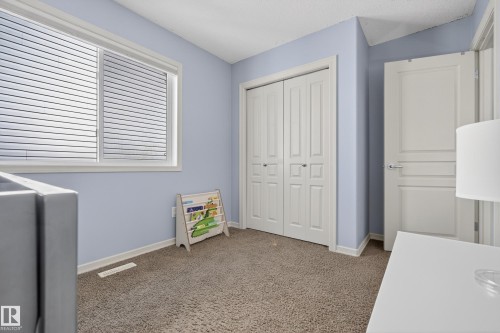 The room features light blue walls, a window with horizontal blinds, and carpeted flooring - 20714 56A Avenue, Edmonton, AB - Indoor Photo Showing Other Room