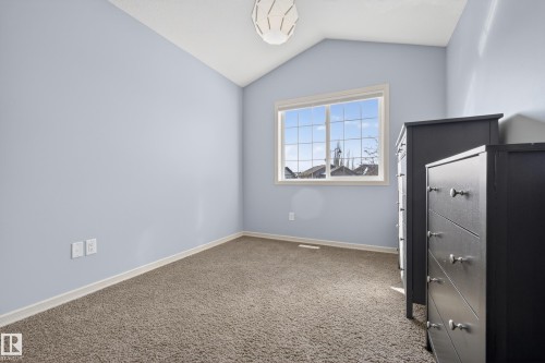 This room features carpeted flooring, light blue walls, and a window providing natural light - 20714 56A Avenue, Edmonton, AB - Indoor Photo Showing Other Room