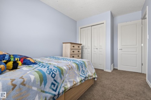 This room features soft blue walls and brown carpeting - 20714 56A Avenue, Edmonton, AB - Indoor Photo Showing Bedroom