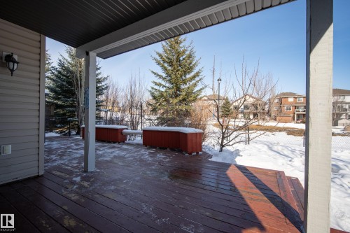 Outdoor deck featuring a dark stained wooden surface and a covered patio area - 20714 56A Avenue, Edmonton, AB - Outdoor With Deck Patio Veranda