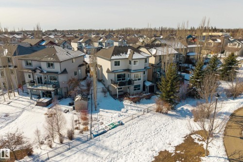 The property features a two-story exterior with balconies and a fenced backyard, including a shed and hot tub - 20714 56A Avenue, Edmonton, AB - Outdoor