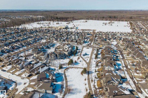 Aerial view of the property and its surrounding residential area, featuring a park with winding pathways - 20714 56A Avenue, Edmonton, AB - Outdoor With View