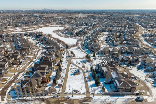 Aerial view of the property and its surrounding neighbourhood, featuring a nearby pond and park - 20714 56A Avenue, Edmonton, AB - Outdoor With View