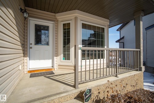 The property features a concrete porch with a gray railing - 20714 56A Avenue, Edmonton, AB - Outdoor With Deck Patio Veranda With Exterior