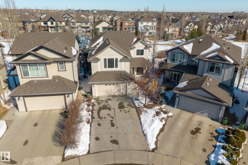 The property features a two-car garage, a paved driveway, and a front entrance with a covered porch - 20714 56A Avenue, Edmonton, AB - Outdoor With Facade