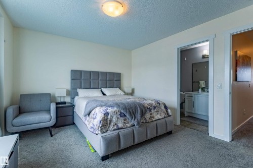 This bedroom features light-colored walls and carpeted flooring, creating a neutral canvas - 2679 Maple Way, Edmonton, AB - Indoor Photo Showing Bedroom