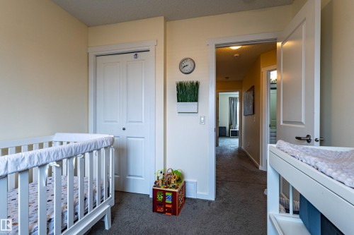 The room features light-colored walls and grey carpet flooring - 2679 Maple Way, Edmonton, AB - Indoor Photo Showing Bedroom