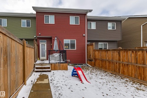 The property features a private fenced yard with a small deck and a concrete pathway leading to the back entrance - 2679 Maple Way, Edmonton, AB - Outdoor With Deck Patio Veranda With Exterior