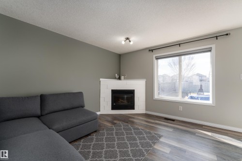 w/ gas fireplace - 5911 8 Avenue, Edmonton, AB - Indoor Photo Showing Living Room With Fireplace