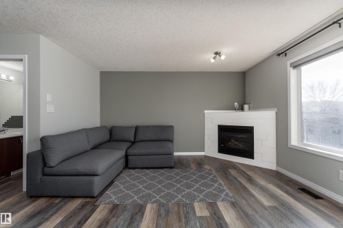 w/ gas fireplace - 5911 8 Avenue, Edmonton, AB - Indoor Photo Showing Living Room With Fireplace