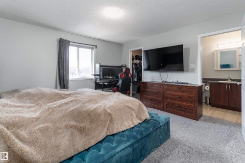w/ two separate walk-in closets and private 4pc ensuite bathroom - 5911 8 Avenue, Edmonton, AB - Indoor Photo Showing Bedroom