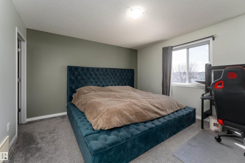 w/ two separate walk-in closets and private 4pc ensuite bathroom - 5911 8 Avenue, Edmonton, AB - Indoor Photo Showing Bedroom